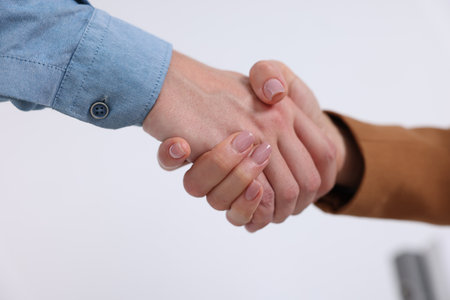 Business partners shaking hands in office, closeupの写真素材