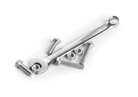 Metal wrench, bolts and nuts isolated on white