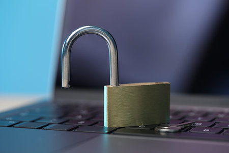 Cyber safety. Metal padlock on laptop, closeup