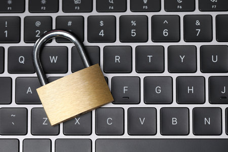 Cyber safety. Metal padlock on keyboard, top viewの写真素材