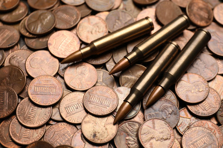 Many firearms cartridges on coins, closeup viewの写真素材