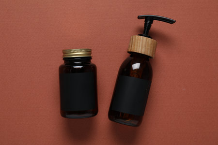Cosmetic products on brown background, flat lay. Mockup for designの写真素材