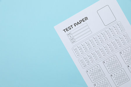 Student passing exam. Answer sheet on light blue background, top view. Space for textの写真素材