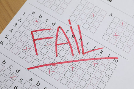 Answer sheet with word Fail on table, closeup. Student passing examの写真素材