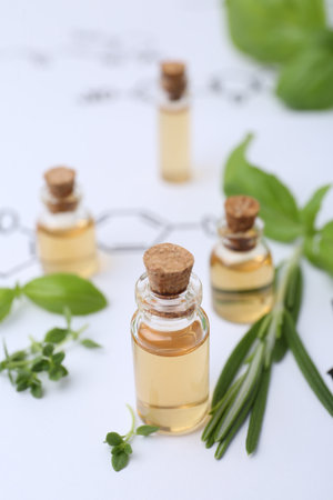 Different herbs and bottles of cosmetic products on paper with chemical formulas, closeupの写真素材