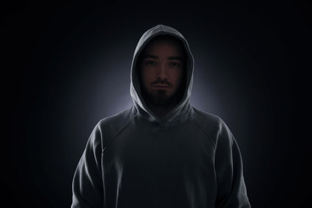 Man in hood on dark backgroundの写真素材