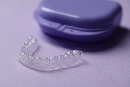 One clear aligner and retainer case on violet background, closeupの写真素材