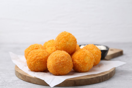Fried croquette balls on gray table, closeup