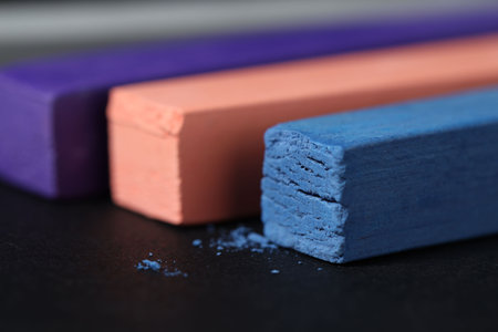 Colorful chalk pastels on black background, closeupの写真素材