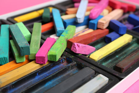 Set of colorful chalk pastels on pink background, closeupの写真素材