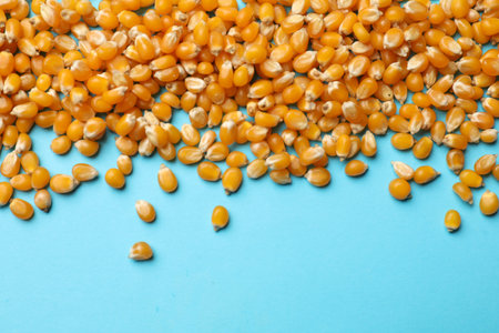 Dry kernels on light blue background, flat lay. Space for text