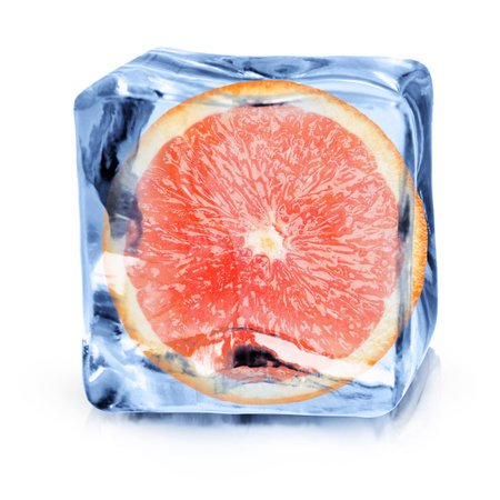 Half of fresh orange inside ice cube on white backgroundの写真素材