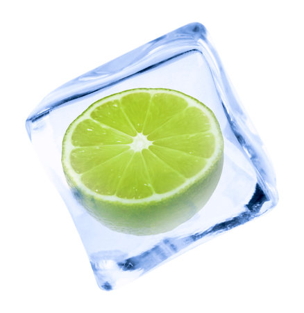 Cut fresh lime fruit in ice cube isolated on whiteの写真素材