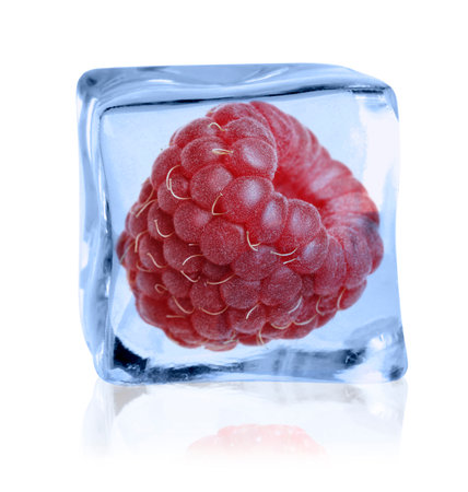 Ripe raspberry in ice cube on white backgroundの写真素材