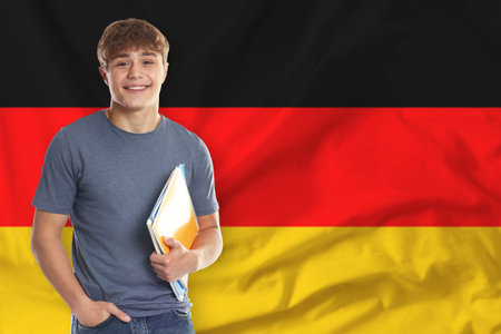 Student with notebooks against flag of Germany.の写真素材