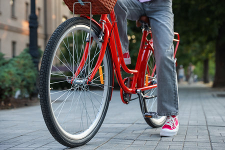 Teenage girl riding bicycle on city street, closeupの写真素材