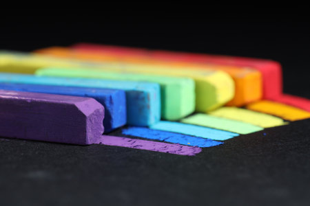 Colorful chalk pastels on black background, closeupの写真素材
