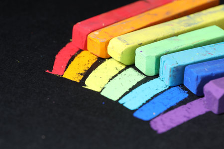 Colorful chalk pastels on black background, closeupの写真素材