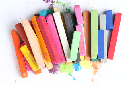 Many colorful chalk pastels on white background, top viewの写真素材