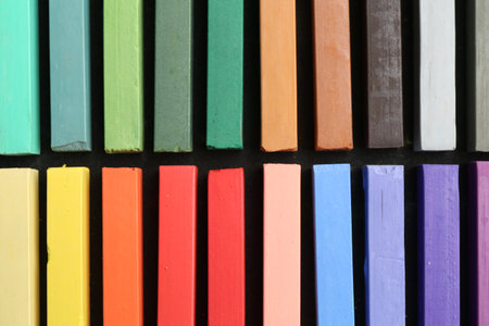 Colorful chalk pastels on black table, top viewの写真素材