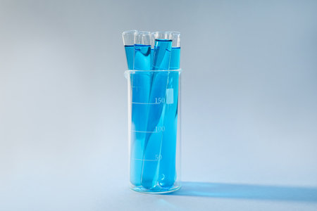 Test tubes with blue liquid on light backgroundの写真素材