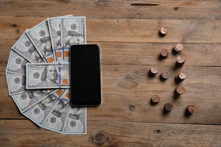 Smartphone and money on wooden table, flat layの写真素材