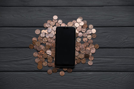 Smartphone and money on wooden table, flat layの写真素材