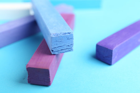 Colorful chalk pastels on light blue background, closeupの写真素材
