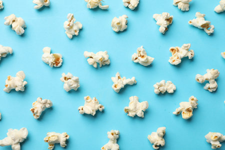 Tasty popcorn on light blue background, flat layの写真素材