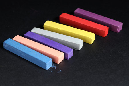 Colorful chalk pastels on black background, closeupの写真素材