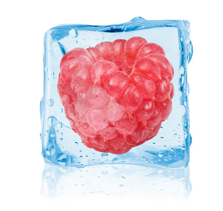 Ripe raspberry in ice cube on white backgroundの写真素材