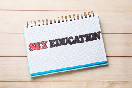 Notebook with words Sex Education on wooden table, top viewの写真素材
