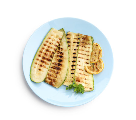 Delicious grilled courgette slices with parsley and lemon isolated on white, top viewの写真素材