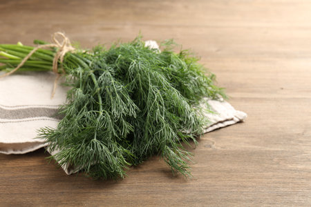 Bunch of fresh dill on wooden table, closeupの写真素材
