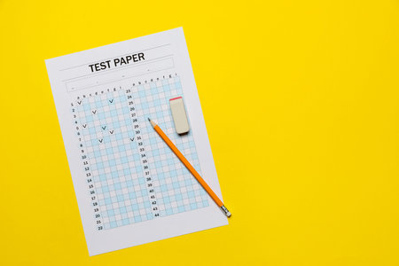 Student passing exam. Answer sheet, pencil and eraser on yellow background, flat lay. Space for text