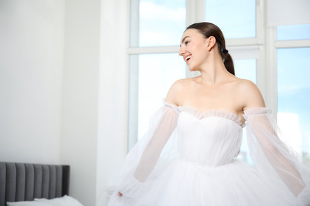Dreams come true. Woman in beautiful wedding dress at home, space for textの写真素材