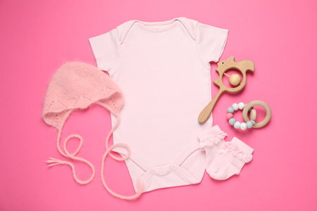 Stylish baby clothes and accessories on pink background, flat layの写真素材