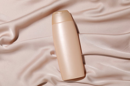 Cosmetic product on beige fabric, top view. Mockup for designの写真素材