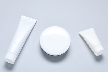 Cosmetic products on light background, flat lay. Mockup for design