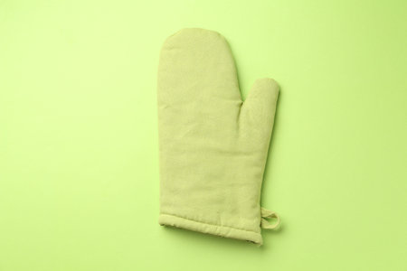 One oven glove on green background, top viewの写真素材