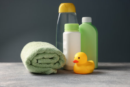 Baby bath accessories and care products on grey tableの写真素材