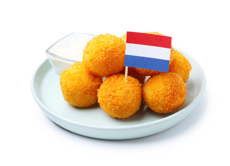 Delicious fried croquette balls and flag of Netherlands isolated on whiteの写真素材