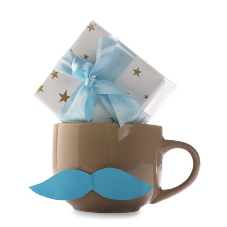 Happy Father's Day. Cup with mustache and gift box isolated on whiteの写真素材