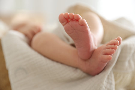Cute newborn child lying in baby nest indoors, closeupの写真素材