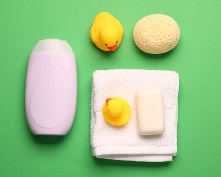 Baby bath accessories on green background, flat layの写真素材