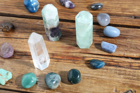 Different healing stones on wooden table, closeupの写真素材
