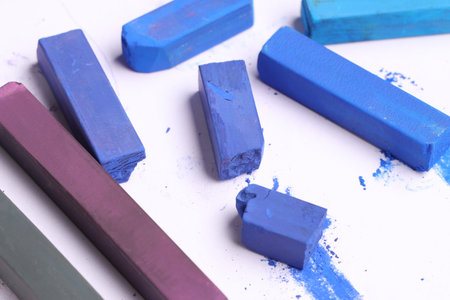 Colorful chalk pastels on white background, closeup