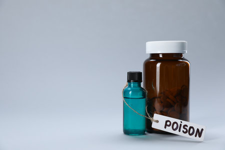 Bottles of poisons on light gray background, space for textの写真素材