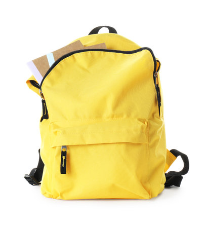Yellow backpack with notebooks isolated on white