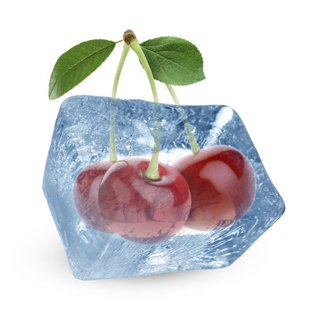 Fresh cherries in clear ice cube isolated on whiteの写真素材